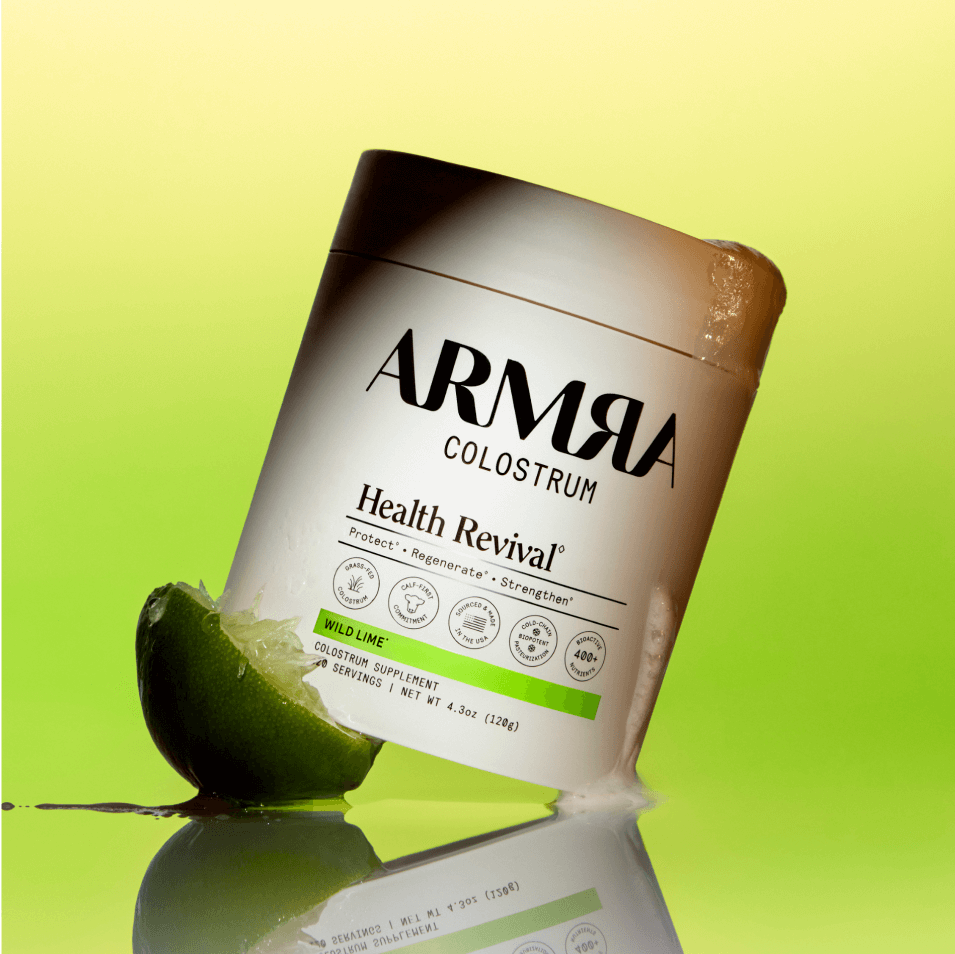 Jar of ARMRA Colostrum Health Revival Wild Lime on a green background
