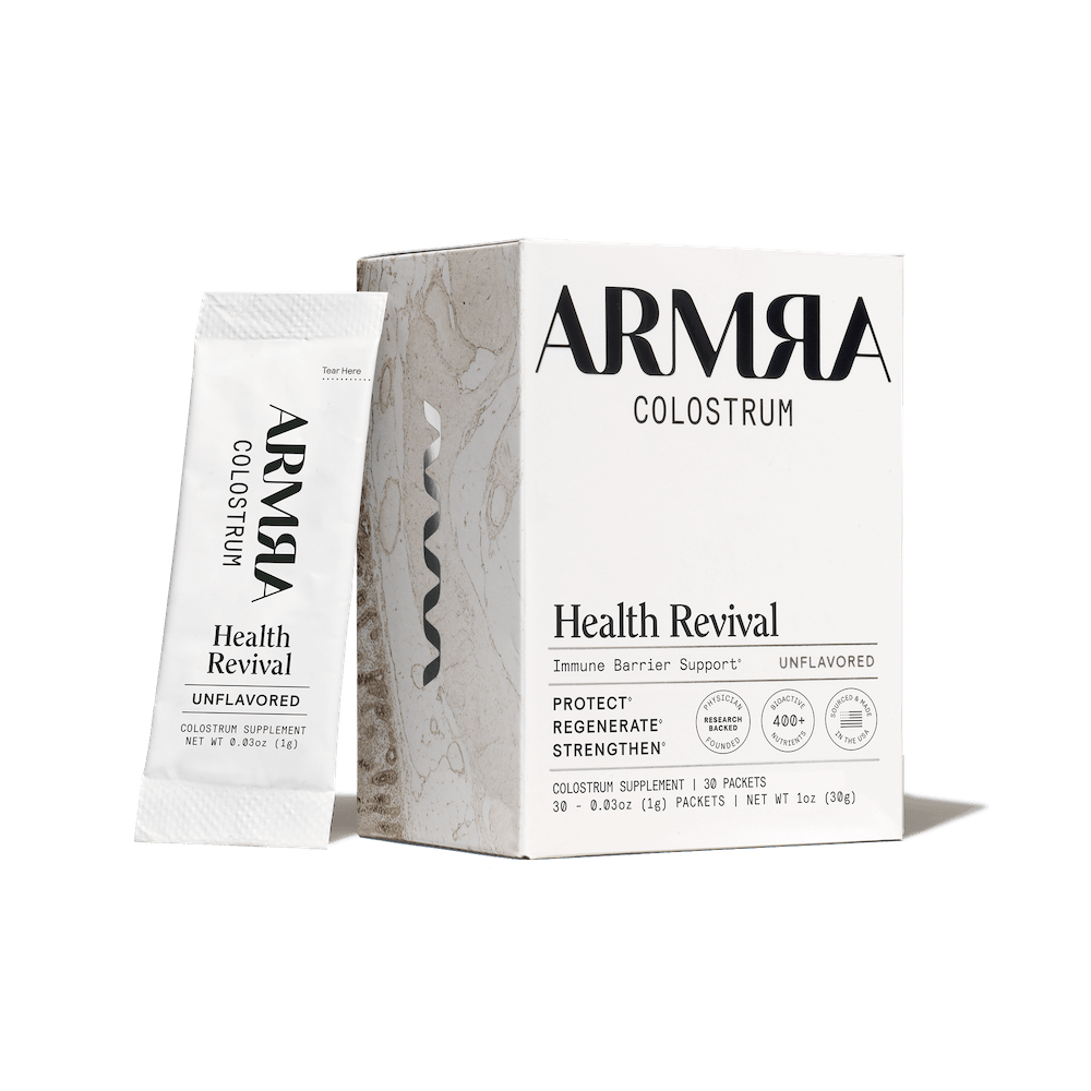 ARMRA Colostrum Health Revival packaging on a black background